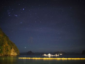 Scenic view of lake against sky at night