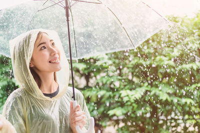 Portrait of beautiful young woman in rain