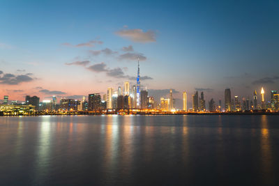 Illuminated city at waterfront