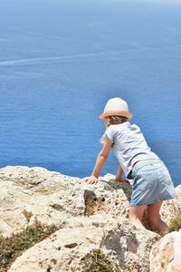 Girl standing on rocks at beach