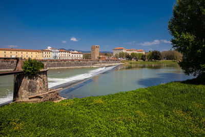 View of bridge over river with buildings in background