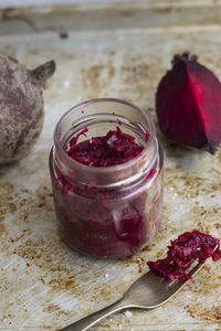 High angle view of beetroot chutney in jar in table