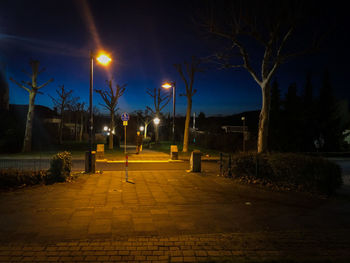 Street lights on sidewalk at night