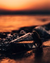 Close-up of water against sky at sunset