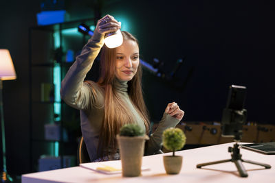 Portrait of young woman using mobile phone