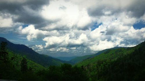 Scenic view of mountains against cloudy sky