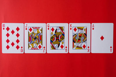 Close-up of cards on red table