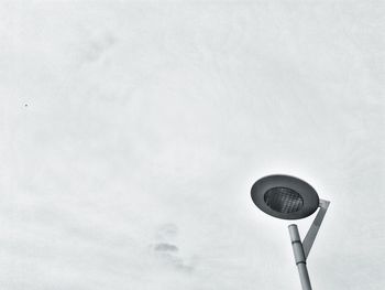 Low angle view of lighting equipment on street against sky