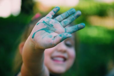 Close-up of green colored hand