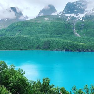 Scenic view of lake and mountains against sky