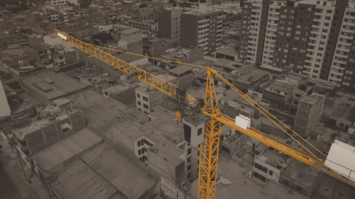 High angle view of construction site by buildings in city