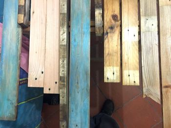 Low section of man standing on wooden floor