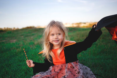 Portrait of a smiling young woman on field