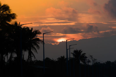 Silhouette palm trees against sky during sunset