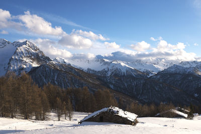 Scenic view of snow covered mountains against sky