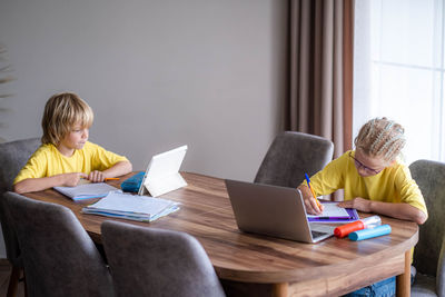 Woman using laptop while sitting at home