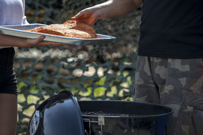 Mid section of man barbecuing