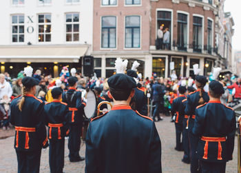 Rear view of marching band on street during festival