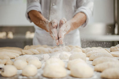 Midsection of man preparing food