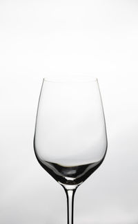 Close-up of wineglass against white background