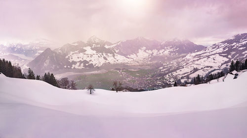 Scenic view of snowcapped mountains against sky