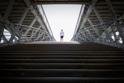 Low angle view of man walking on staircase