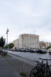 City street by buildings against sky