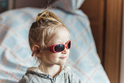 Portrait of boy wearing sunglasses at home