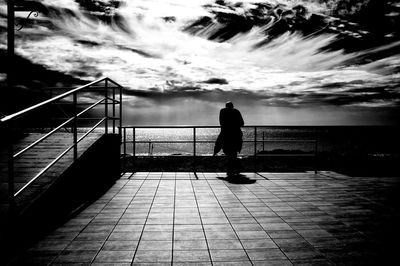 Person standing by railing