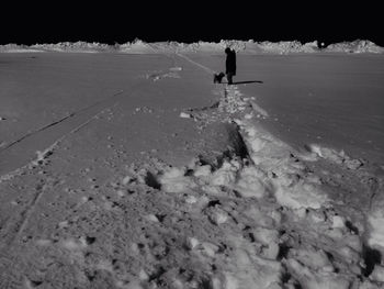 People standing on snow covered landscape