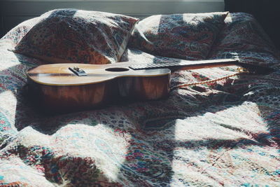 Guitar on bed at home