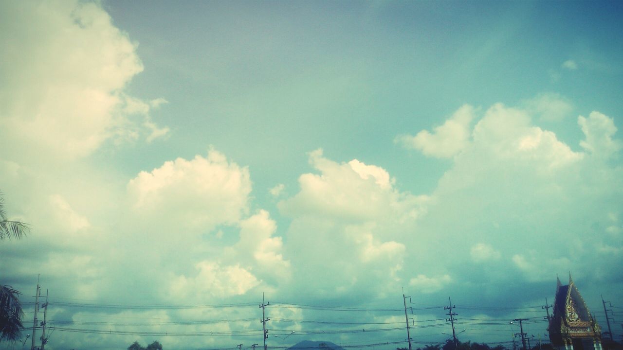 sky, low angle view, cloud - sky, power line, blue, cloudy, cloud, electricity pylon, nature, tranquility, power supply, electricity, beauty in nature, weather, fuel and power generation, day, outdoors, no people, cable, scenics