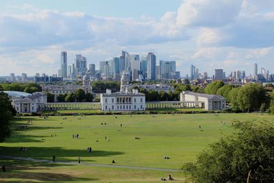 Scenic view of trees and buildings against sky