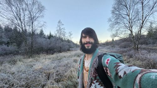 Low section of woman standing on field