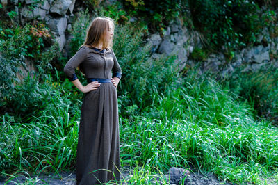 Rear view of woman standing in grass