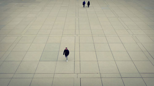 High angle view of woman walking on footpath