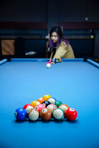 Portrait of woman playing pool