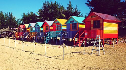 Multi colored umbrellas on beach against sky