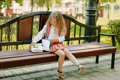 Young woman sitting on bench