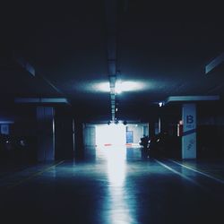 Illuminated underground walkway at night