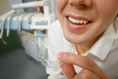 Close-up of dentist holding braces in clinic