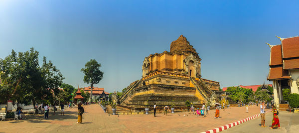 People at temple against sky