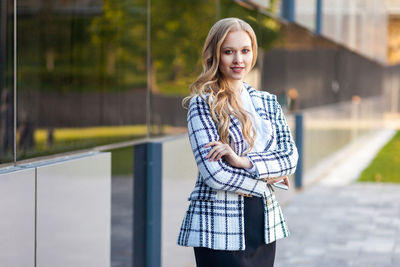 Portrait of smiling young woman standing outdoors