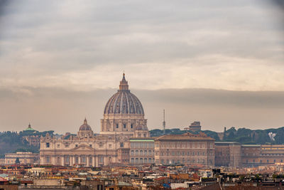 View of st. peter's dome and the rooftops of rome on a cloudy winter day