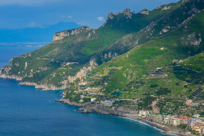 Scenic view of sea and mountains against sky