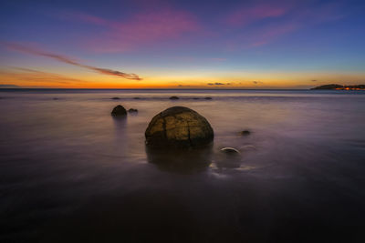 Scenic view of sea against sky at sunset