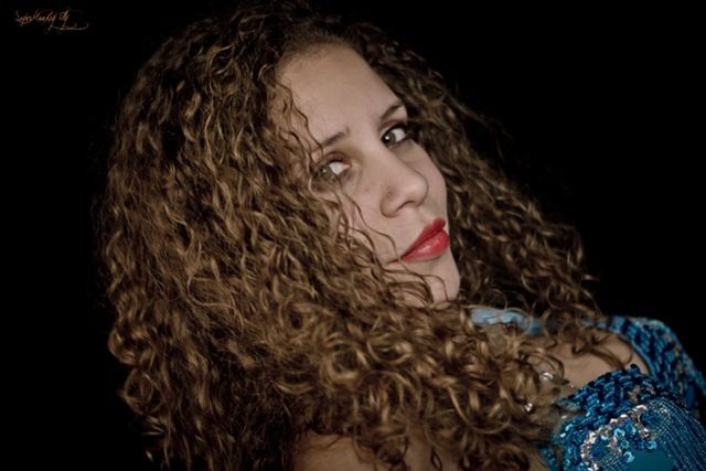 studio shot, person, lifestyles, headshot, portrait, black background, young adult, young women, leisure activity, looking at camera, front view, long hair, close-up, human face, head and shoulders, indoors, waist up