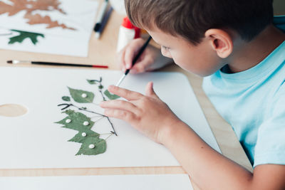 Girl drawing on paper