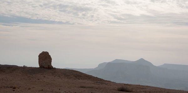 Rock formations on landscape against sky