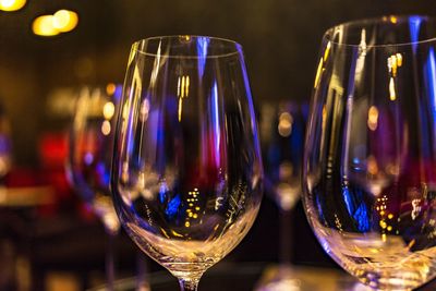 Close-up of wineglasses on restaurant table at night